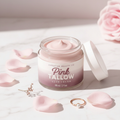 Pink Tallow Luxe Cream open glass jar on white marble with rose petals and botanicals