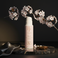 Highland Pure Akari Brightening Facial Cleanser on dark marble with cherry blossom